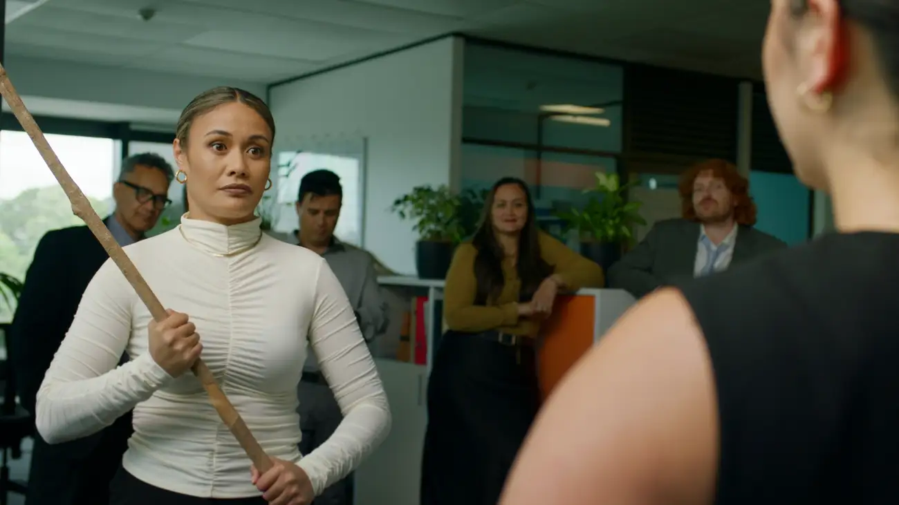 Geo holds a staff, ready to strike, in a law firm.