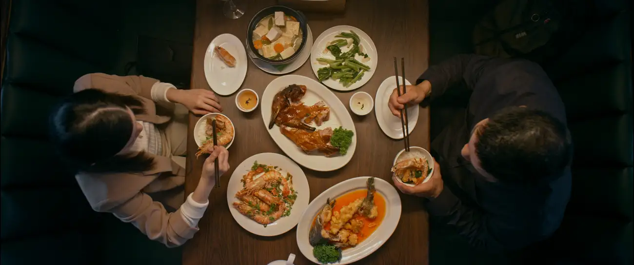 Top down view of a restaurant table full of Chinese food.