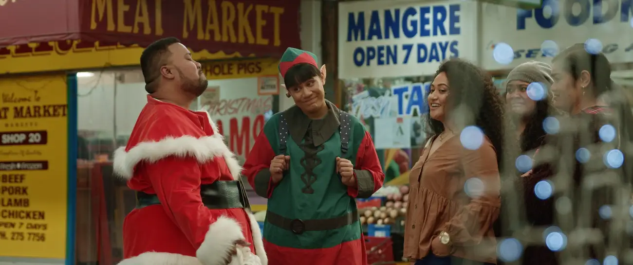 A Tongan Santa, a Samoan Elf and bemused women meet at Mangere Town Center.
