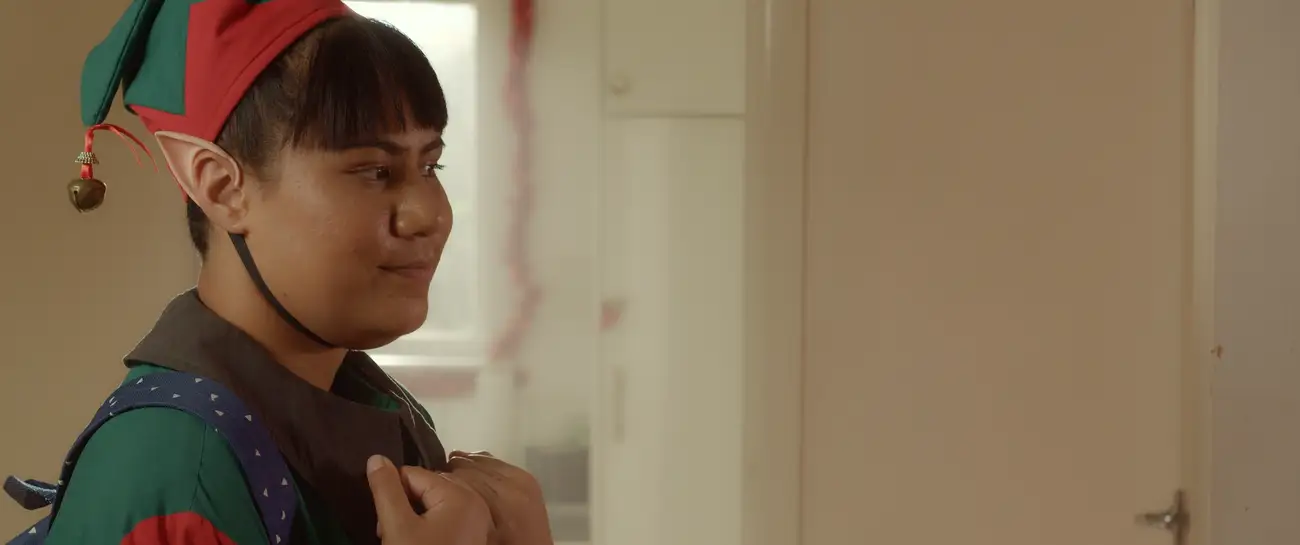 A Samoan elf looks lovingly at her grandma.