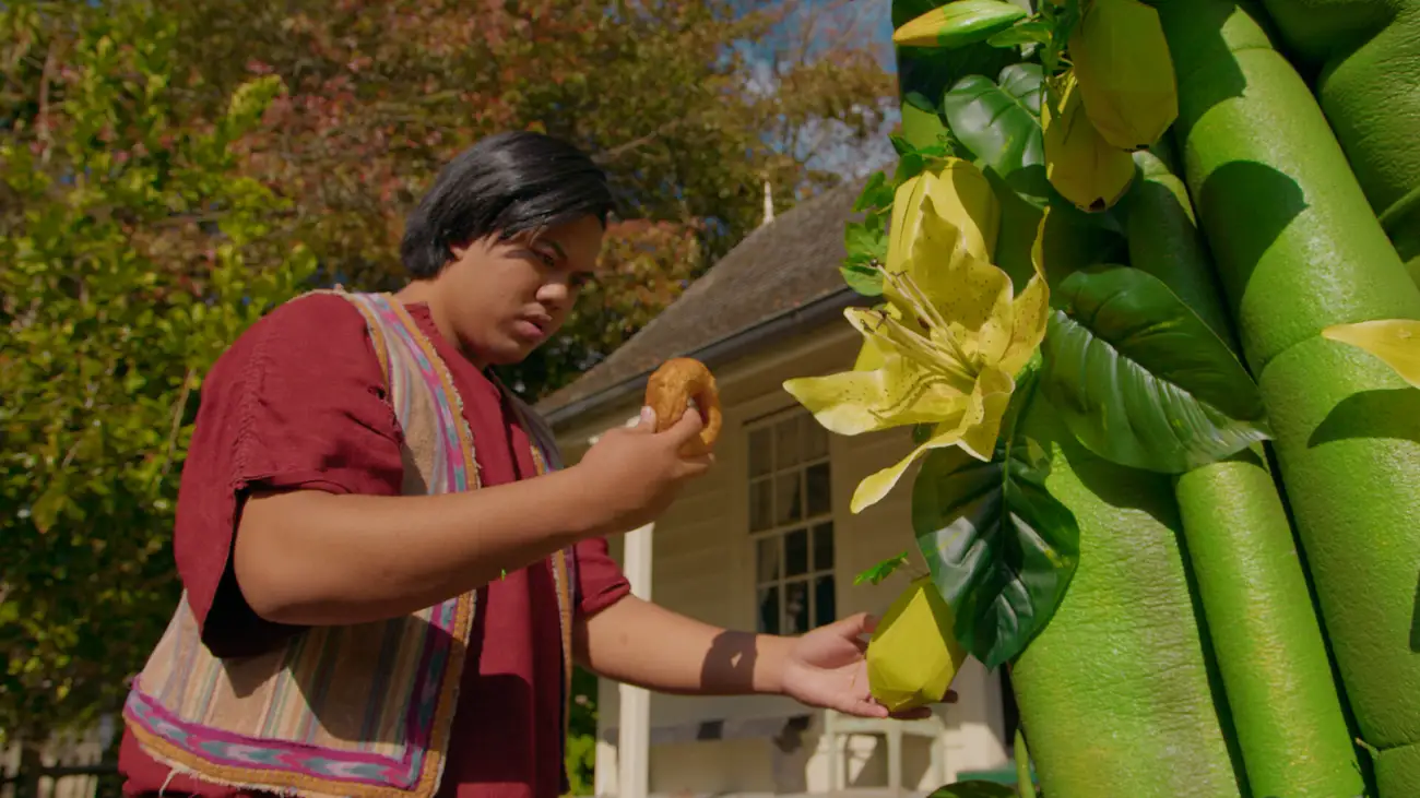 A young man finds a donut growing from a magic beanstalk.