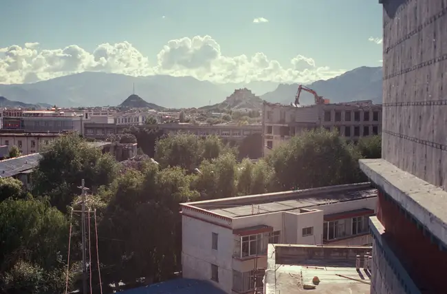 Demolition in Lhasa, Tibet, with Potala Palace in the distance.
