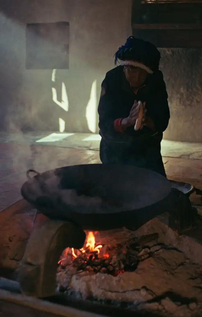 Gemachu-nainai prepares a Tibetan toasted momo using the ashes of her hearth.