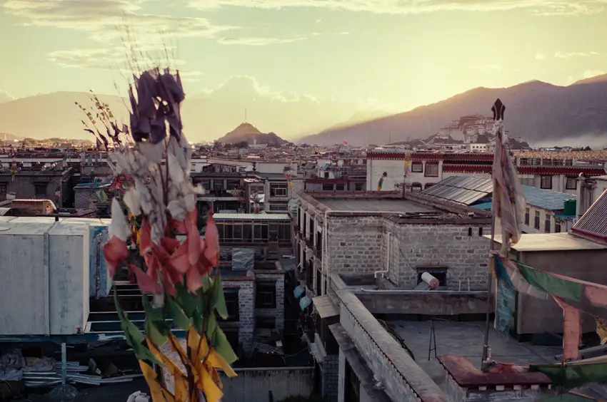 Skyline of Lhasa, Tibet, taken from a rooftop restaurant, with Potala Palace in the distance.