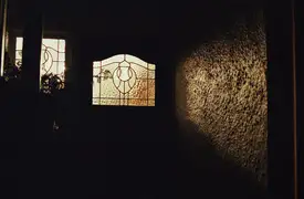 Light shining from the front door of a house in Dunedin.