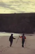 Dad hands Mum her walking stick.
