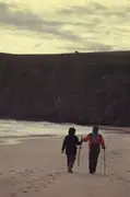 Dad hands Mum her walking stick.