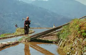 A farmer on rice terraces in Jiabang, Guizhou.