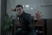 Winson holds a strong kung fu pose in a modern Chinese diner.