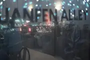 Looking into a Chinese restaurant through the front window, with the words 'Yuanfen Alley' in the foreground.