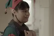 A Samoan elf looks lovingly at her grandma.